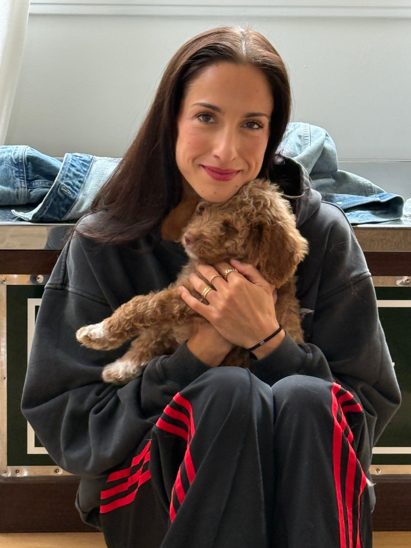 A Kid's Best Doodle family member holding her Goldendoodle puppy close