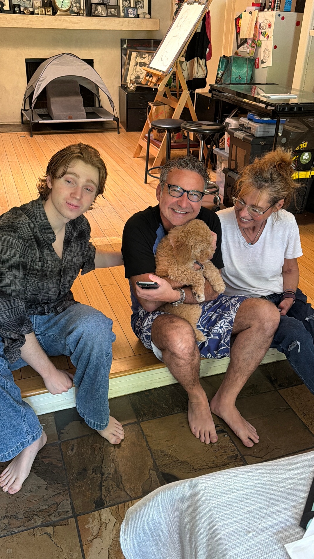 A Kid's Best Doodle family of three at home with their mini Goldendoodle puppy after a concierge homecoming